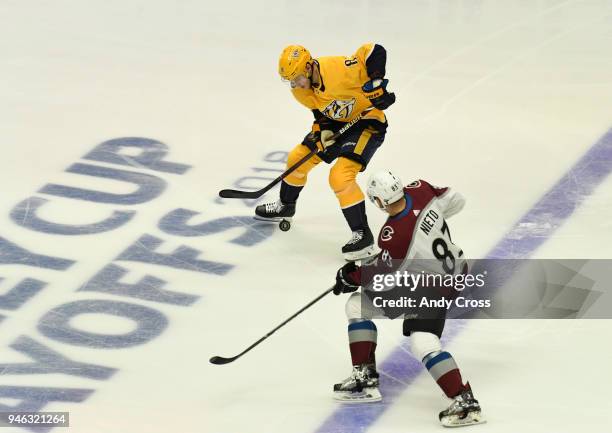 Nashville Predators center Kyle Turris and Colorado Avalanche left wing Matt Nieto get after the puck in the first period during the second game of...