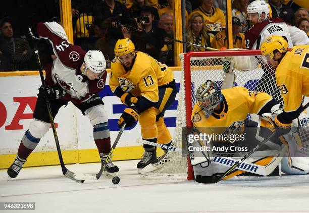 Colorado Avalanche center Carl Soderberg goes after the puck against Nashville Predators center Nick Bonino in front of Nashville Predators...