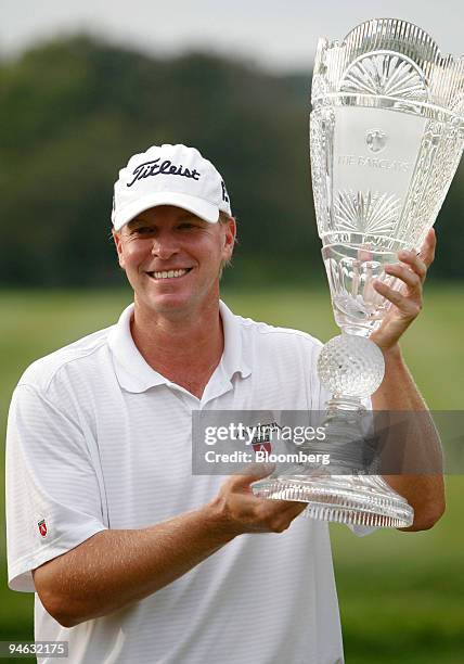 Golfer Steve Stricker holds the Barclays championship cup on the 18th hole of Barclays Classic golf tournament at Westchester Country Club in Rye,...