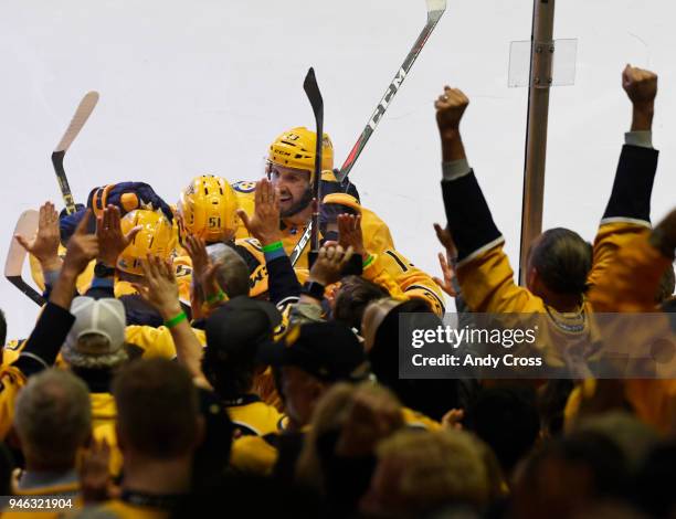 Nashville Predators defenseman Mattias Ekholm and Nashville Predators center Nick Bonino swarm Nashville Predators left wing Austin Watson, center,...