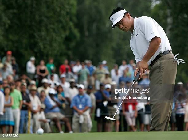 Golfer K.J. Choi hits a putt on the 17th hole in the final round of the Barclays Classic golf tournament at Westchester Country Club in Rye, New...