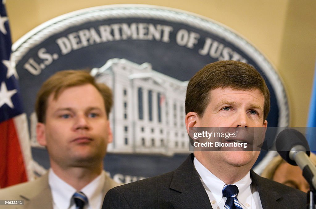 U.S. Deputy Attorney General Paul McNulty, right, delivers r
