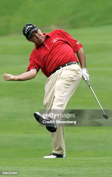 Golfer Rich Beem jokingly pumps his fist after his hit went through a stand of trees, but made it onto the green of hole seven, during the final...