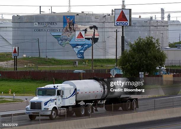 An oil tanker passes storage tanks at the Citgo Refinery in Corpus Christi, Texas, on Thursday, August 10, 2006. Citgo Petroleum Corp., the U.S....