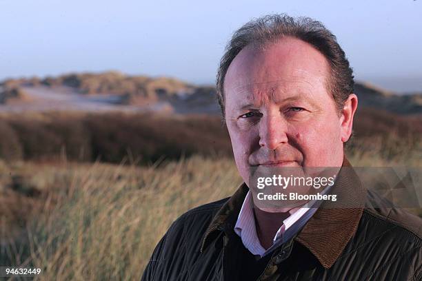 Neil Hobday, project director of Trump International Golf Links, Scotland poses on land where Donald Trump is planning to open a golf course and...