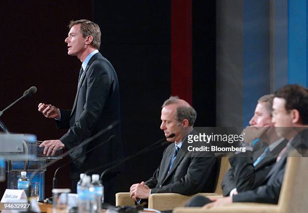 Qualcomm Inc. Chief Executive Officer Paul E. Jacobs, far left, speaks during a session titled ?Digital Intelligence Revolution: Until When and...