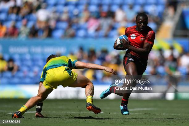 Billy Odhiambo of Kenya takes on Ben O'Donnell of Australia during the Rugby Sevens Men's Placing 5-8th match between Australia and Kenya on day 11...