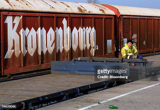 Worker takes a break from loading crates of Kronenbourg beer for transport at the company's brewery in Obernay, France, on Tuesday, Dec. 18, 2007....