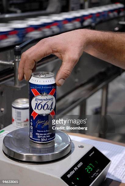 Worker weighs a bottle of Kronenbourg beer at the company's brewery in Obernay, France, on Tuesday, Dec. 18, 2007. Carlsberg A/S Chief Executive...