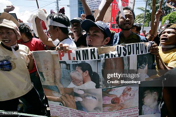 Protesters take part in a demonstration against Richard Ness, president director of Newmont Mining Corp., outside the Manado Court, in Manado,...