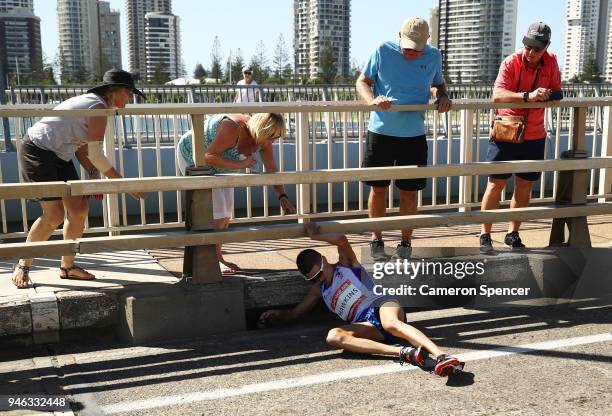 Callum Hawkins of Scotland collapses as he competes in the Men's marathon on day 11 of the Gold Coast 2018 Commonwealth Games at Southport Broadwater...