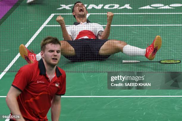 England's Chris Adcock celebrates beating compatriot Marcus Ellis and Lauren Smith in their badminton mixed doubles gold medal match at the 2018 Gold...
