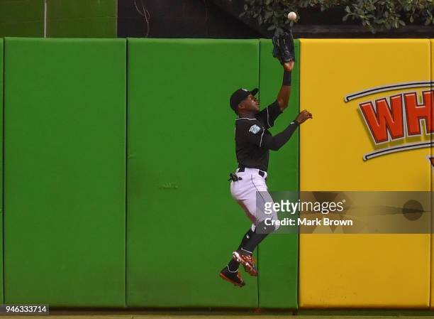 Lewis Brinson of the Miami Marlins makes the leaping catch for an out in the third inning against the Pittsburgh Pirates at Marlins Park on April 14,...