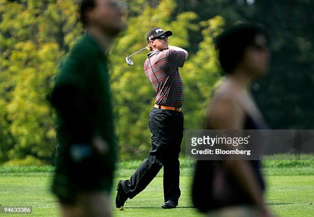 Golfer Hunter Mahan, center, hits a ball down the 15th fairway during the third round of the Barclays Classic golf tournament at Westchester Country...