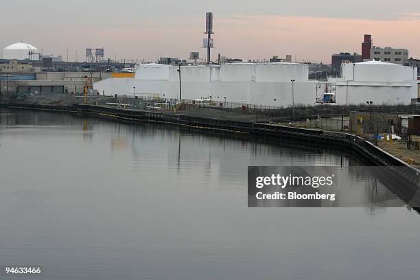 Storage tanks at Exxon Mobil's Brooklyn Terminal, right, are positioned in the Greenpoint neighborhood of Brooklyn along the Newtown Creek, seen in...