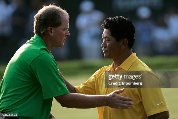 Golfers Steve Stricker, left, and K.J. Choi congratulate each other after completing the third round of the Barclays Classic golf tournament at...