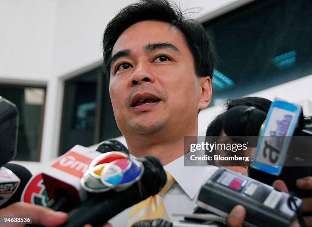 Abhisit Vejjajiva, leader of the Democrat Party, speaks to the media upon arriving at the party headquarters for a meeting of the Democrat's...