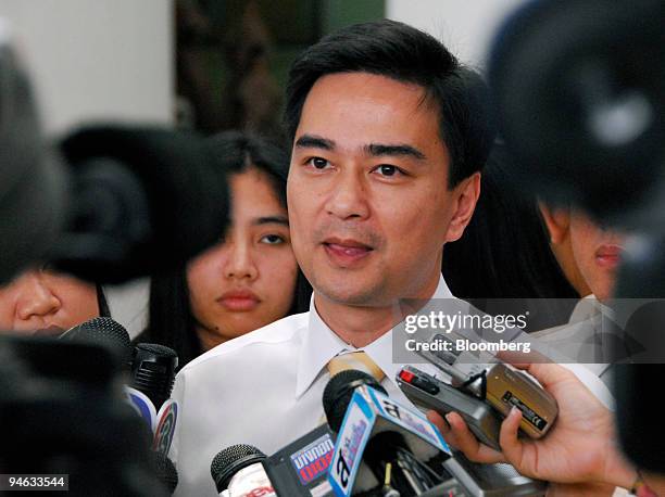 Abhisit Vejjajiva, leader of the Democrat Party, speaks to the media upon arriving at the party headquarters for a meeting of the Democrat's...