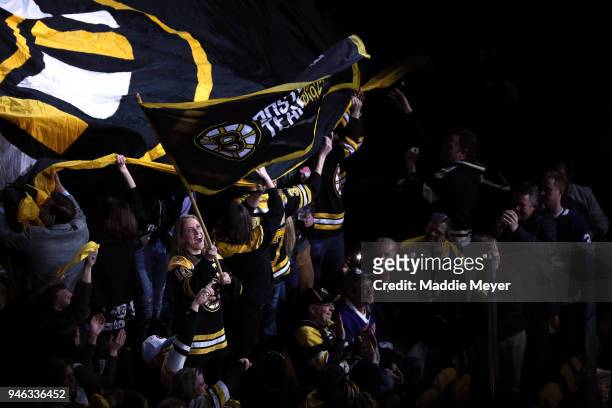 United States Women's National Ice Hockey team captain Meghan Duggan waves a Bruins flag before Game Two of the Eastern Conference First Round during...