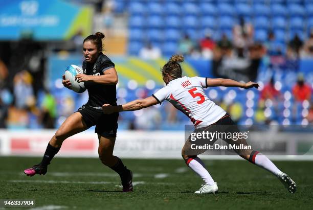 Michaela Blyde of New Zealand takes on Natasha Hunt of England during the Rugby Sevens Women's Semi-Final between New Zealand and England on day 11...