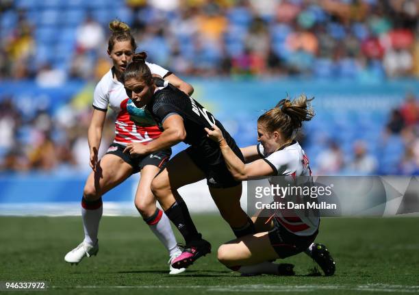 Michaela Blyde of New Zealand is tackled by Lydia Thompson of England during the Rugby Sevens Women's Semi-Final between New Zealand and England on...