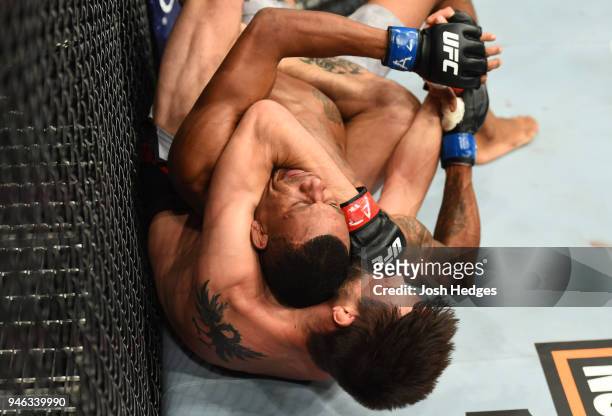 Carlos Condit attempts to submit Alex Oliveira of Brazil in their welterweight fight during the UFC Fight Night event at the Gila Rivera Arena on...