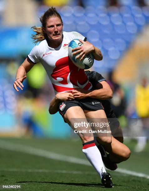 Lydia Thompson of England is tackled by Michaela Blyde of New Zealand during the Rugby Sevens Women's Semi-Final between New Zealand and England on...