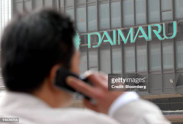 Businessman speaks on his mobile phone opposite a Daimaru Inc. Department store in Tokyo, Japan, on Monday, Feb. 19, 2007. Daimaru Inc., Japan's...