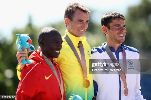 Silver medalist, Munyo Solomon Mutai of Uganda, gold medalist, Michael Shelly of Australia and bronxe medalist, Robbie Simpson of Scotland celebrate...