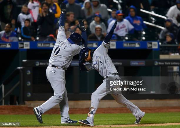 Orlando Arcia of the Milwaukee Brewers celebrates his ninth inning home run against the New York Mets with third base coach Ed Sedar at Citi Field on...