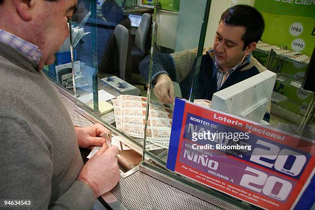 Customer buys lottery tickets from a kiosk in Bilbao, Spain, on Tuesday, Dec.18, 2007. The ''El Gordo'' Christmas lottery, has a top prize of 2.2...