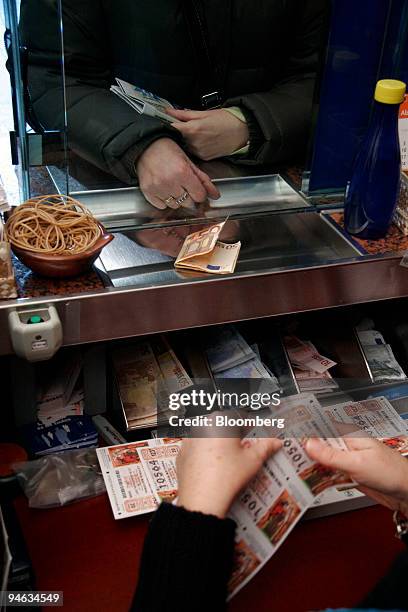 Customer buys lottery tickets from a kiosk in Bilbao, Spain, on Tuesday, Dec.18, 2007. The ''El Gordo'' Christmas lottery, has a top prize of 2.2...