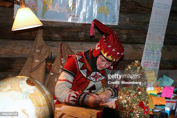 An actors dressed as one of Santa's elves works in Santa's workshop in a tour organized by LaplandHotels near Muonio, Finnish Lapland, Finland,...