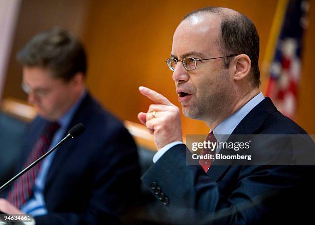 Federal Communications Commissioner Jonathan Adelstein, foreground, speaks out against proposed rules that would let companies own a newspaper and...