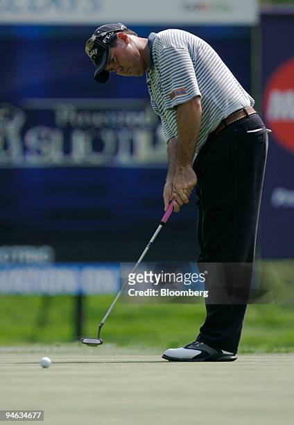 Professional golfer Rich Beem sinks a birdie putt on the 16th hole of the Barclays Classic tournament at Westchester Country Club in Rye, New York,...