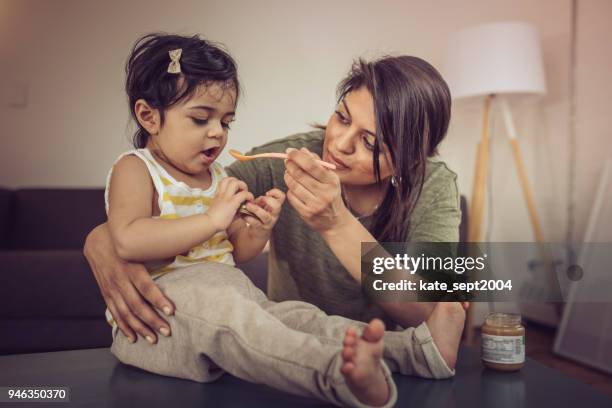 feeding a toddler - indian woman with baby stock pictures, royalty-free photos & images