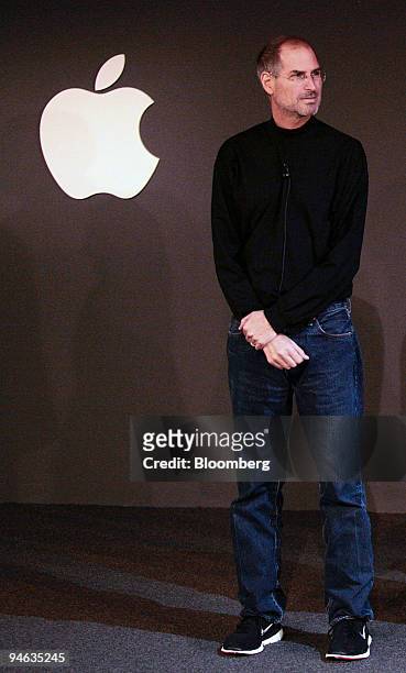 Steve Jobs, chief executive officer of Apple Computer, Inc., listens during a news conference with Mark Parker, president and chief executive officer...