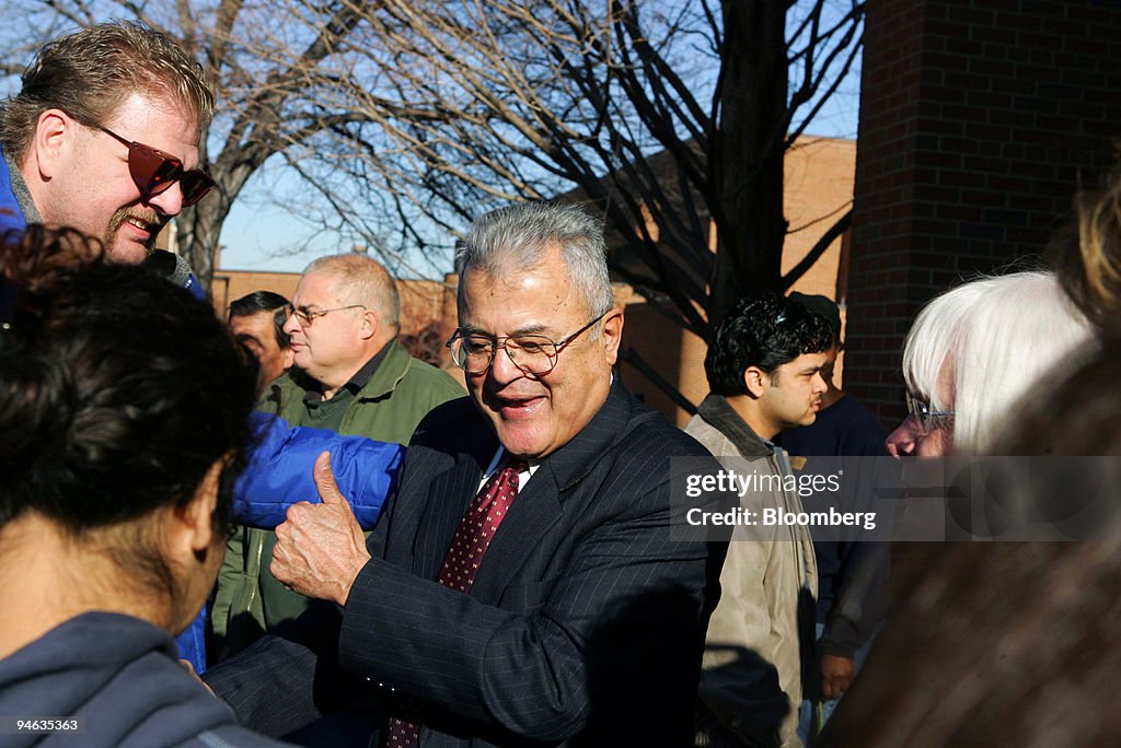 Robert Davila greets students on campus after being introduc