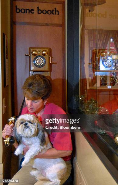 PetSmart Inc. Employee Debbie Long assists Peaches at the Bone Booth, where owners can call and speak to their pets staying at the PetsHotel in...