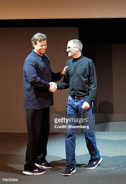 Mark Parker, president and chief executive officer of Nike, Inc., left, shakes hands with Steve Jobs, chief executive officer of Apple Computer,...