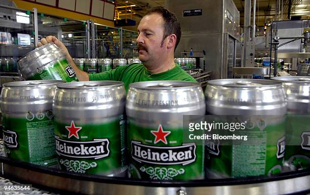 An employee inspects Kegs of Heineken draft beer on the production line at the brewery in Zoeterwoude, The Netherlands, Thursday, Aug. 23, 2007. The...