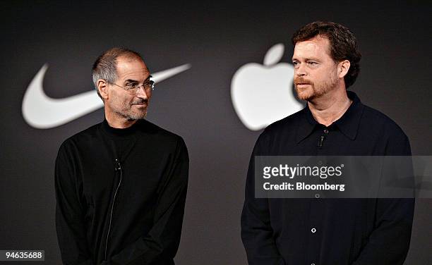 Mark Parker, president and chief executive officer of Nike, Inc., right, speaks as Steve Jobs, chief executive officer of Apple Computer, Inc., looks...