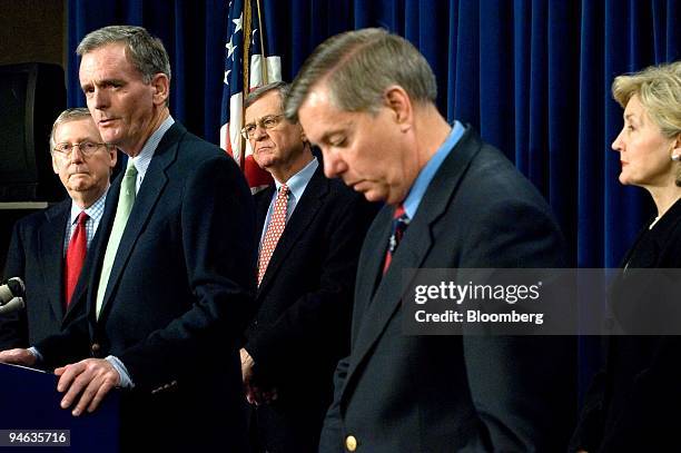 Judd Gregg, a Republican senator from New Hampshire, second from the left, speaks during a news conference following a rare Saturday Senate session...