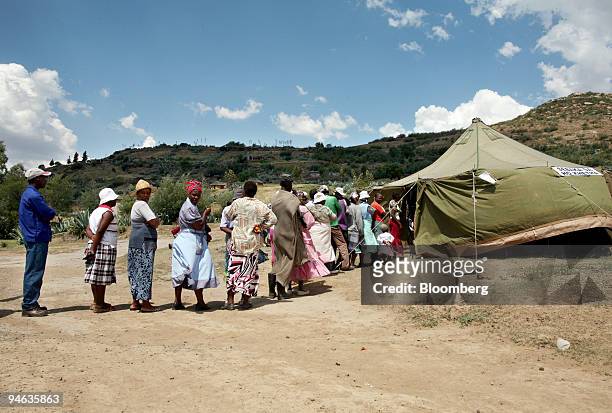 Voters gather outside a small rural voting station 40 km outside Maseru, Lesotho, on Saturday, Feb. 17, 2007. Voters in the southern African kingdom...