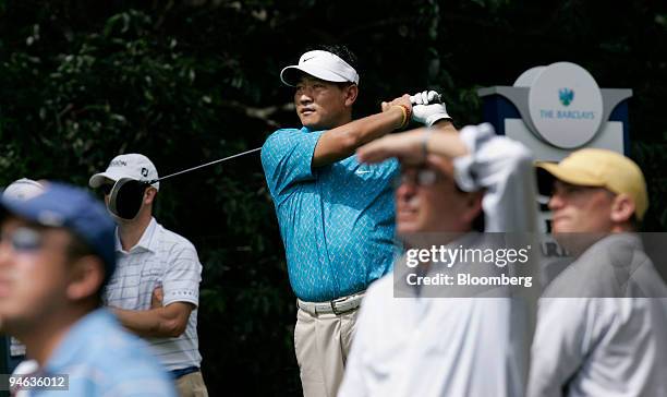 Professional golfer K.J. Choi hits a tee shot as spectators watch at the 5th tee during the Barclays Classic tournament at Westchester Country Club...
