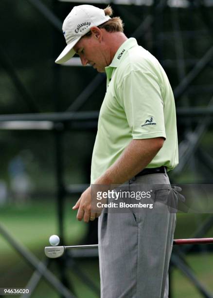 Professional golfer Ernie Els bounces a ball off his putter as he stands on the 17th green at the Barclays Classic tournament at Westchester Country...
