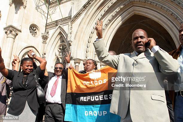 Oliver Bancoult, right, celebrates with other Chagos islanders at the High Court in London, Thursday, May 11, 2006. Natives of the Indian Ocean...