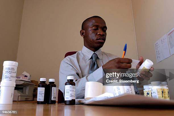 Pharmacist labels an array of antiretroviral drugs at the Nthabiseng Clinic, in Soweto, South Africa, Thursday, Dec. 14, 2006.