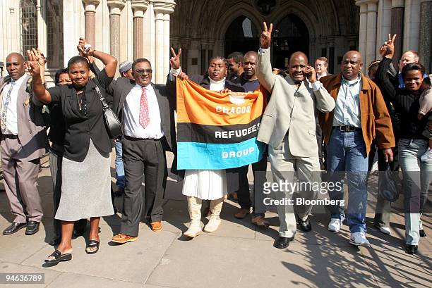 Oliver Bancoult, third right, celebrates with other Chagos islanders at the High Court in London, Thursday, May 11, 2006. Natives of the Indian Ocean...