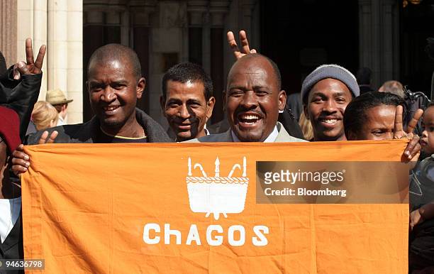 Oliver Bancoult, center right, celebrates with other Chagos islanders at the High Court in London, Thursday, May 11, 2006. Natives of the Indian...